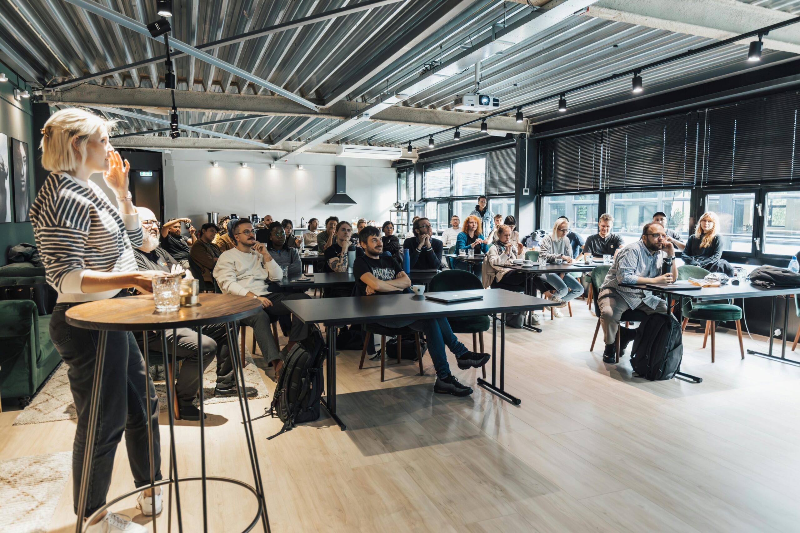 A lively business workshop engaging a diverse audience in a modern conference room.